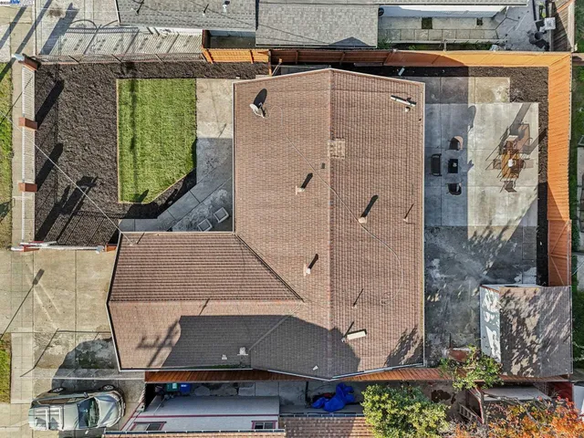 an aerial view of a house with a yard