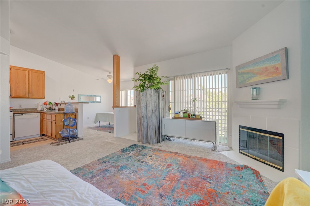 3318 North Decatur Boulevard, Unit 2072 Las Vegas, NV 89130 - Photo 9 of 50 A well-lit living area features an inset fireplace and sliding glass doors that open to the outdoors.