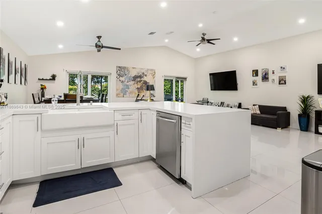 a kitchen with a sink a stove and microwave