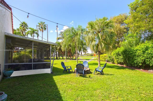 a view of a swimming pool with a patio and a yard