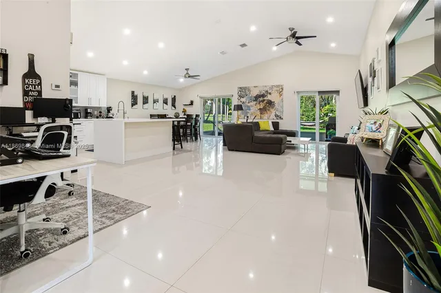 a view of a kitchen with kitchen island stainless steel appliances refrigerator stove microwave and cabinets