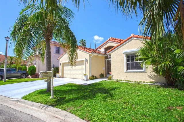 a front view of house with yard and green space