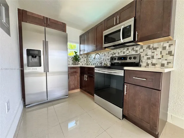 a bathroom with a granite countertop toilet sink and mirror