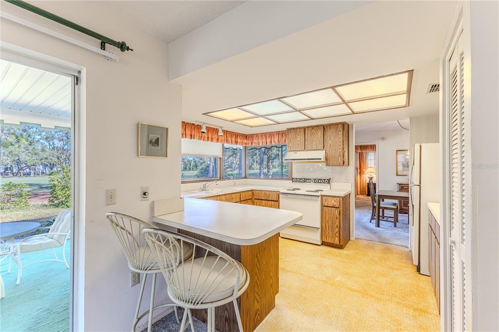 2193 Timber Lodge Lane Spring Hill, FL 34606 - Photo 18 of 73 a kitchen with a table and chairs in it