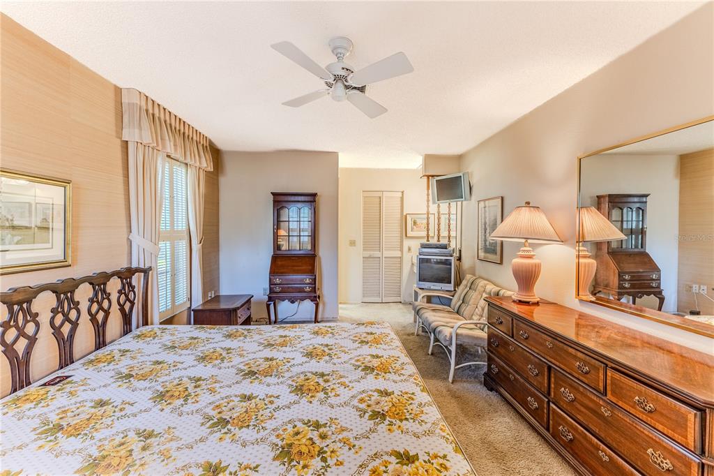 2193 Timber Lodge Lane Spring Hill, FL 34606 - Photo 33 of 73 a bedroom with a bed and a large mirror with a chandelier