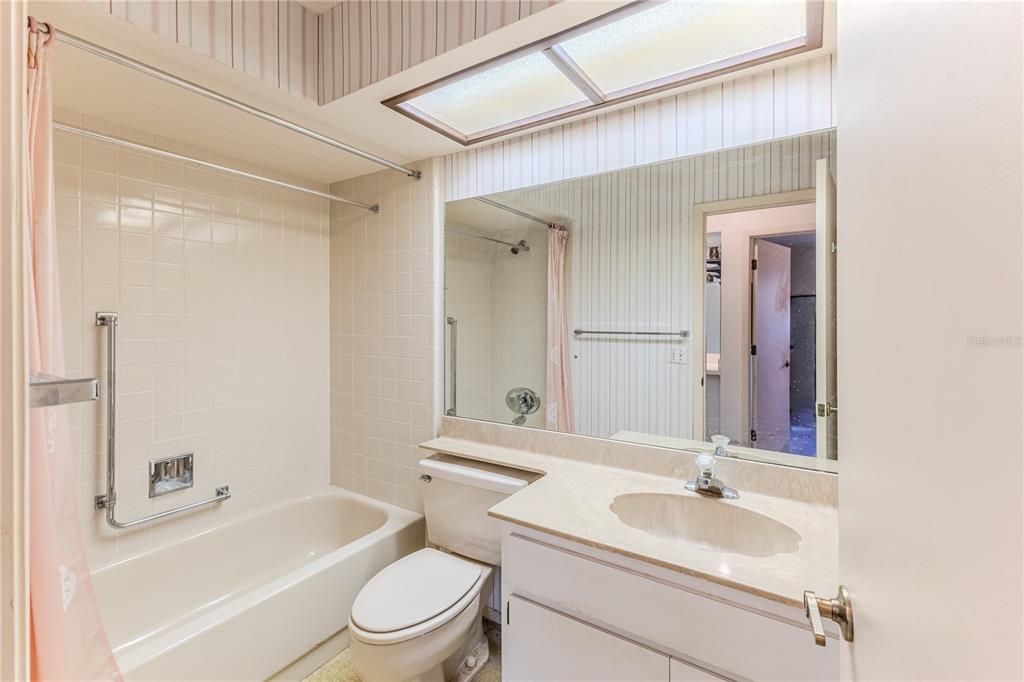 2193 Timber Lodge Lane Spring Hill, FL 34606 - Photo 44 of 73 a bathroom with a granite countertop sink toilet a mirror and bathtub