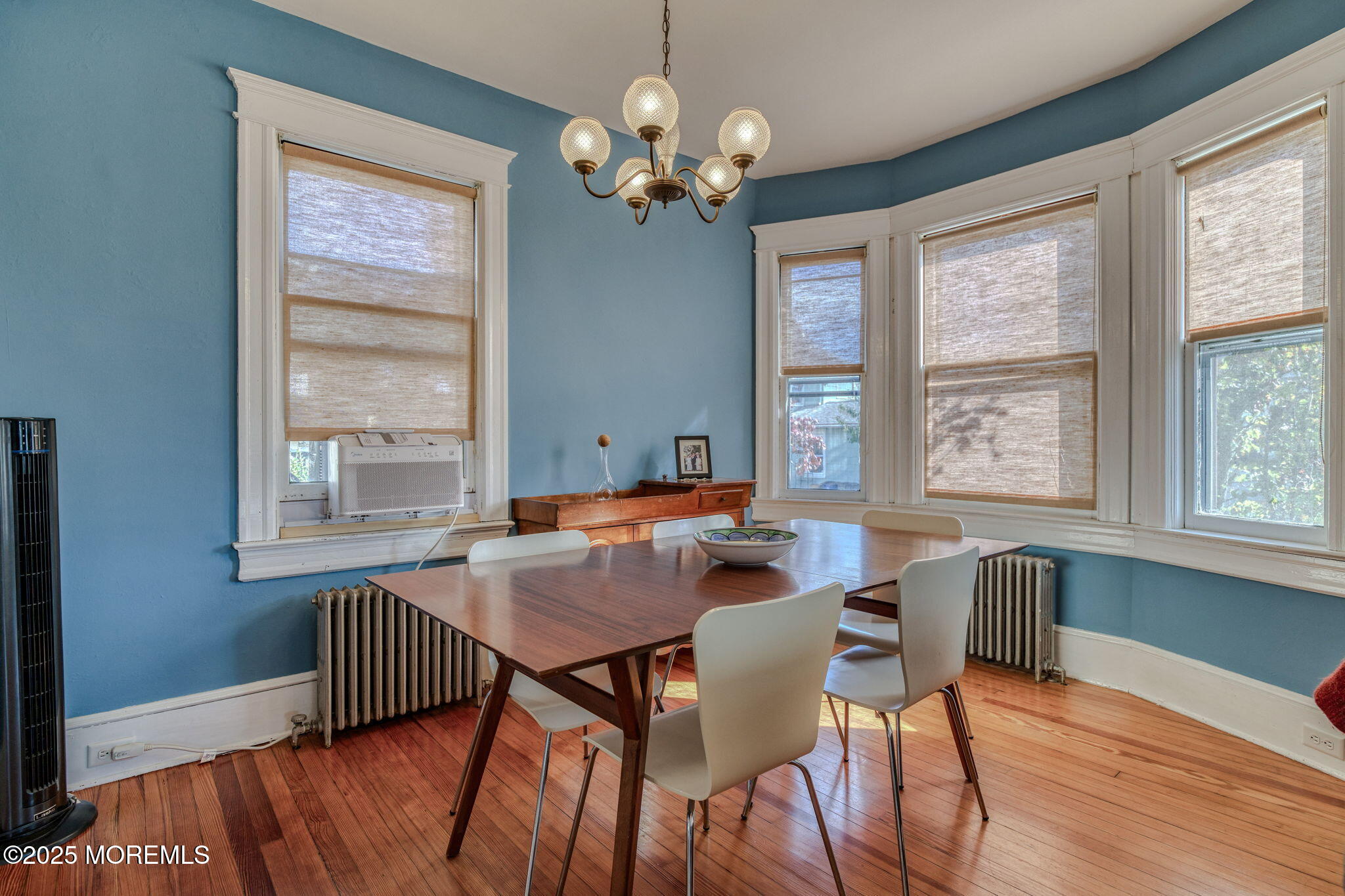 139 Cookman Avenue Ocean Grove, NJ 07756 - Photo 16 of 58 a dining room with wooden floor a chandelier a wooden table and chairs