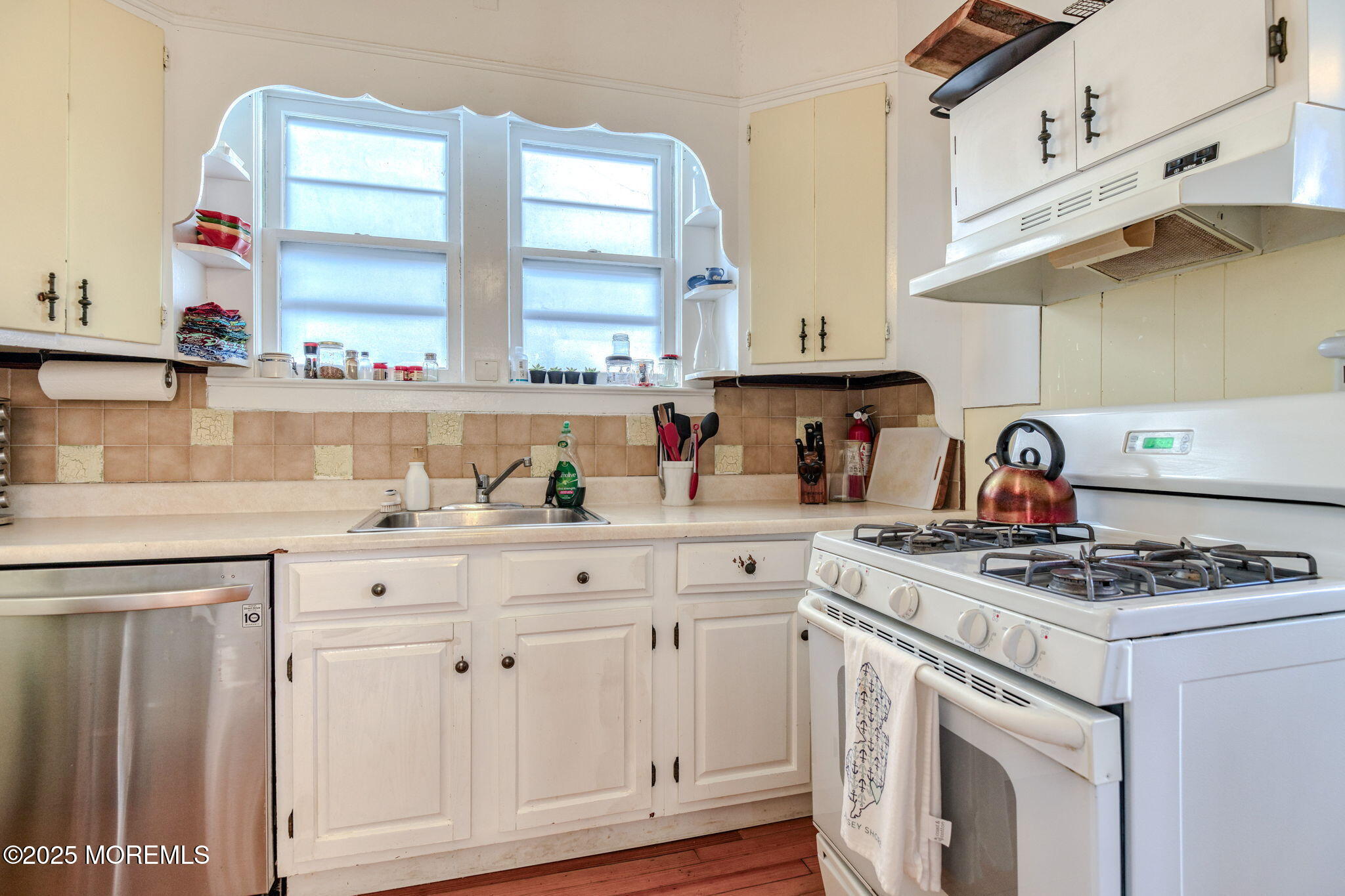 139 Cookman Avenue Ocean Grove, NJ 07756 - Photo 18 of 58 a kitchen with white cabinets and appliances