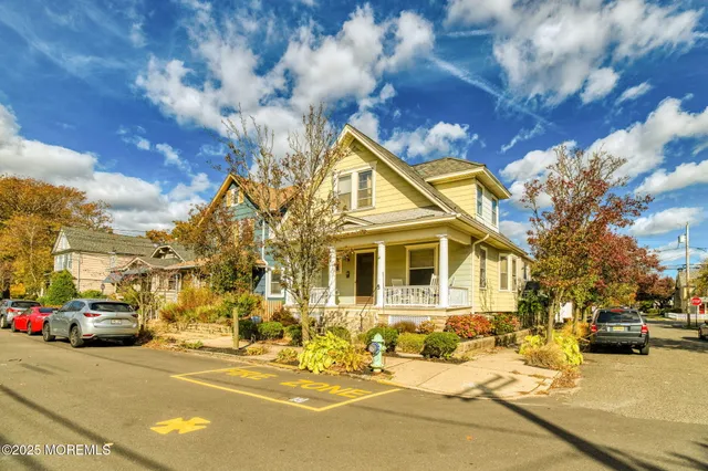 a view of a street that has couple of cars parked on the roadside
