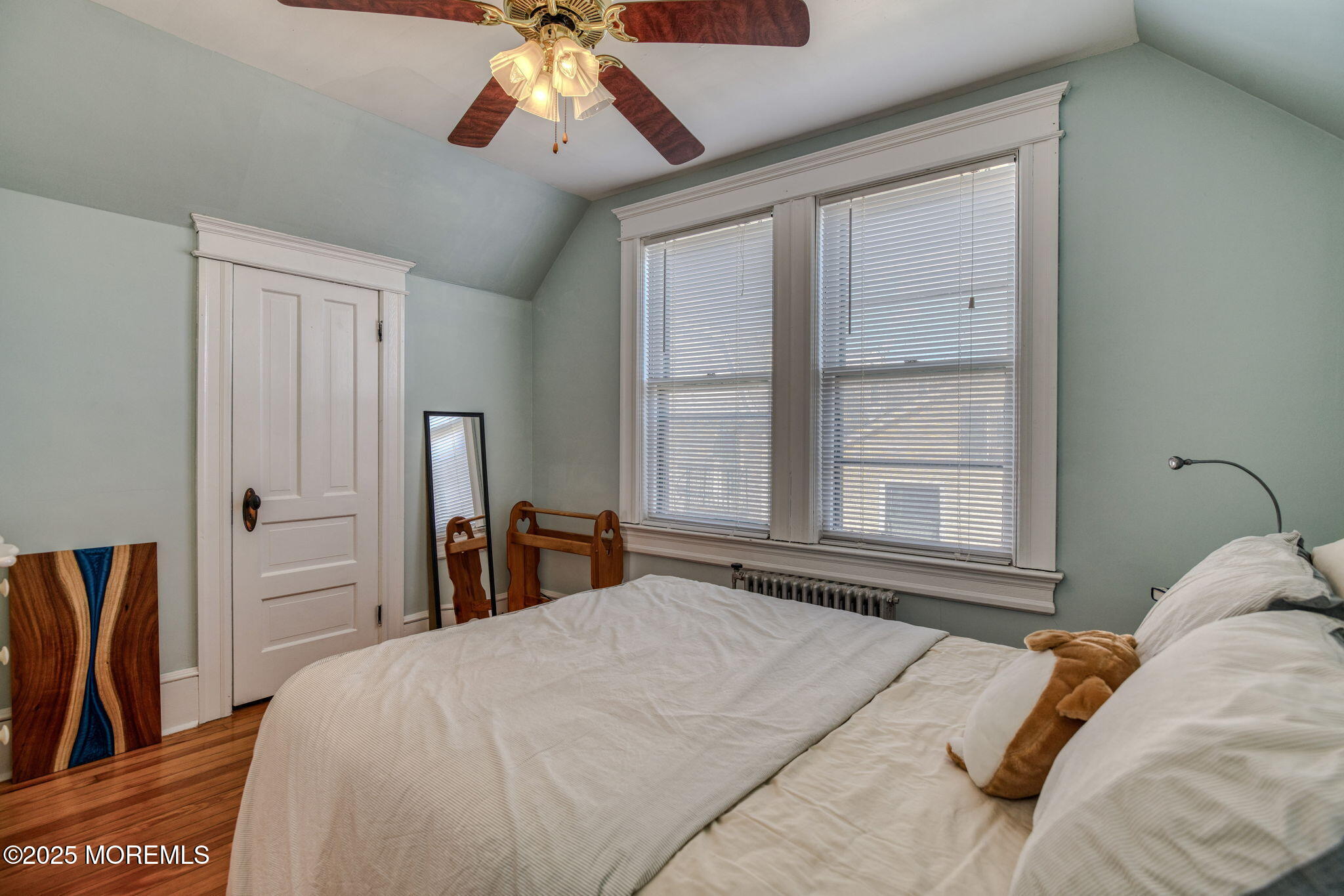 139 Cookman Avenue Ocean Grove, NJ 07756 - Photo 31 of 58 a bedroom with a large bed and a chandelier
