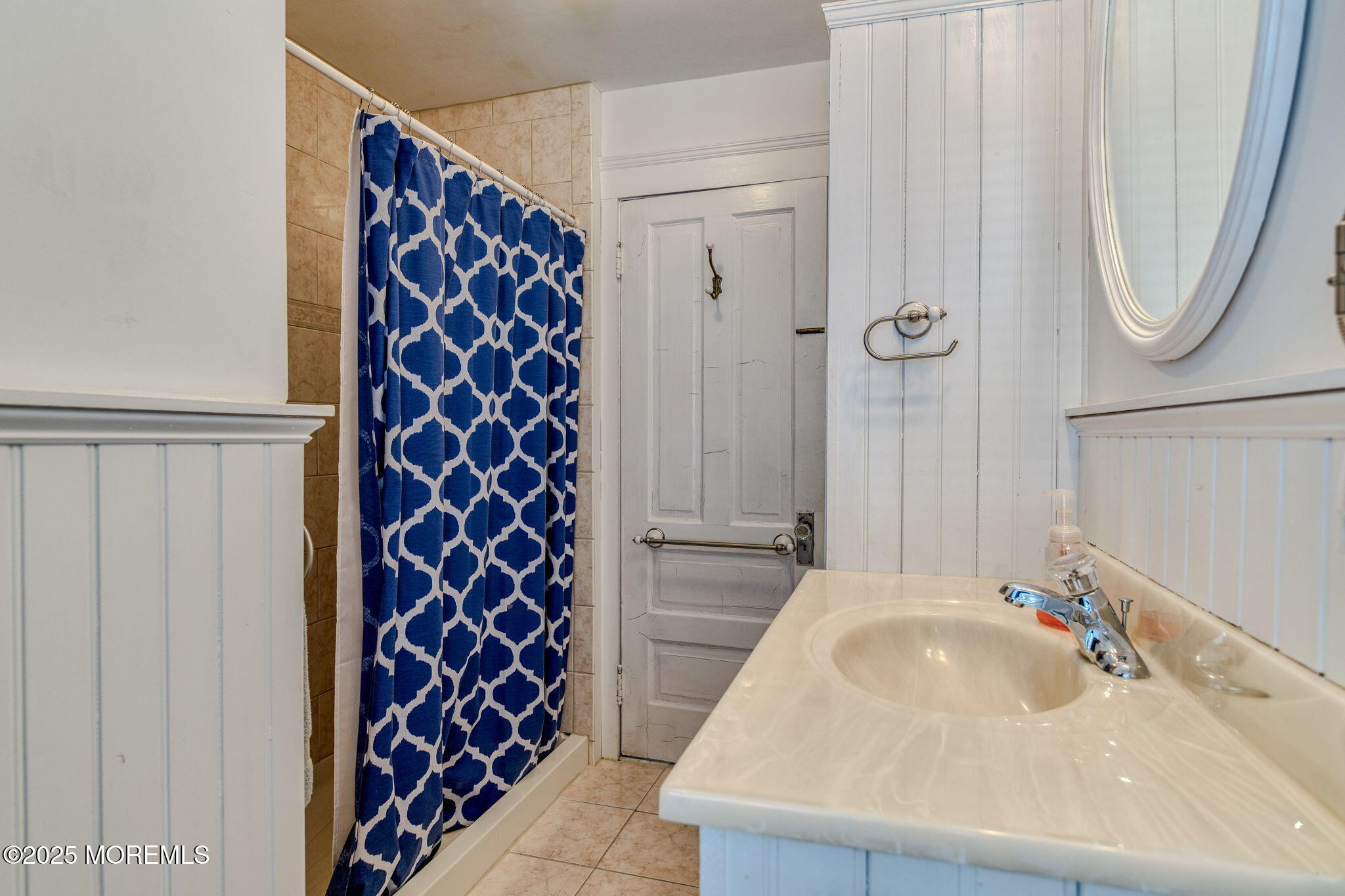 139 Cookman Avenue Ocean Grove, NJ 07756 - Photo 37 of 58 a bathroom with a sink and a mirror