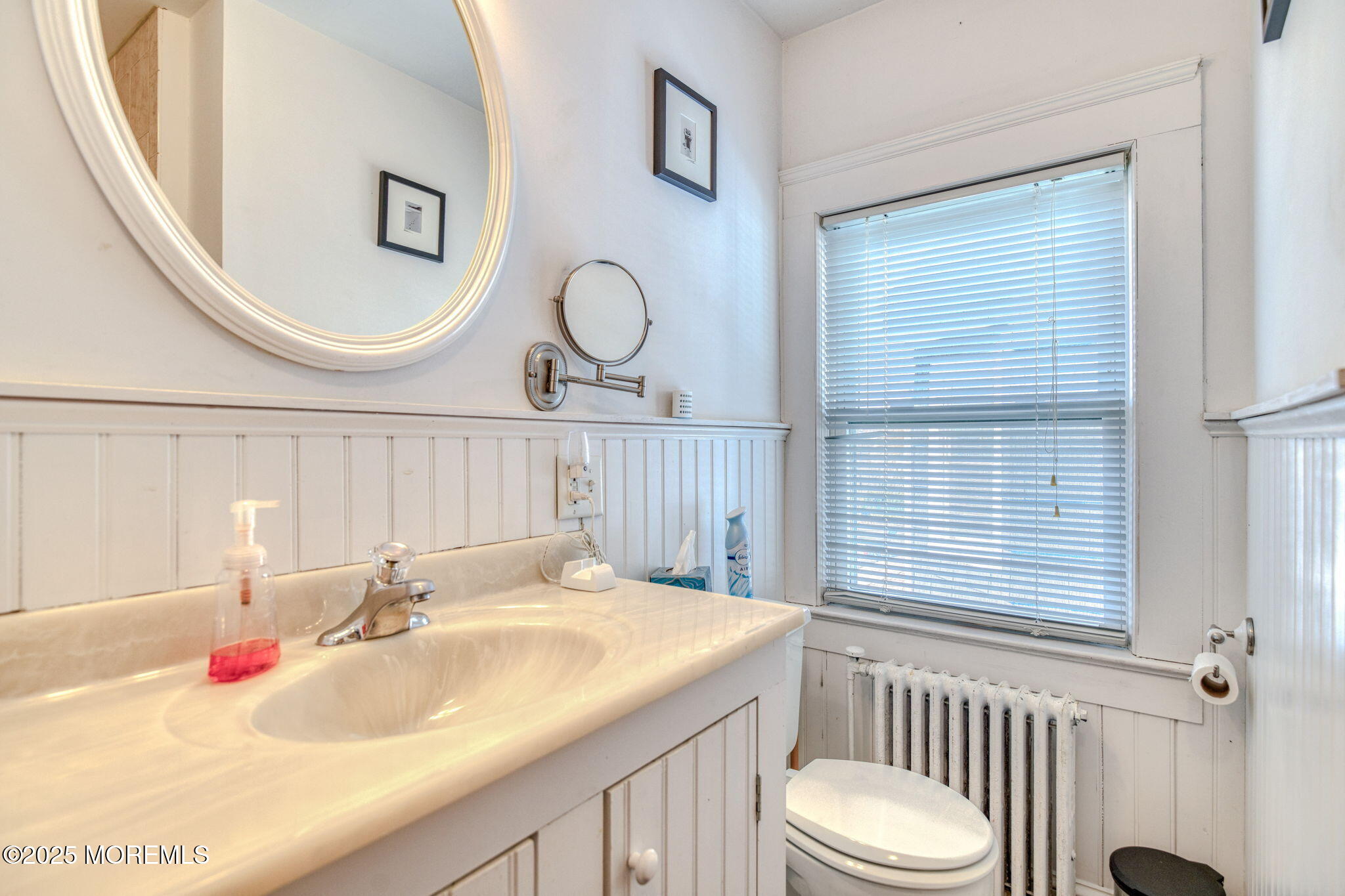 139 Cookman Avenue Ocean Grove, NJ 07756 - Photo 38 of 58 a bathroom with a sink a toilet and a mirror