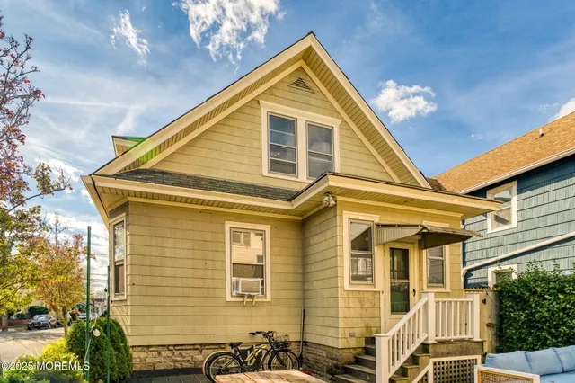 a view of a patio with couches and a potted plant on a table