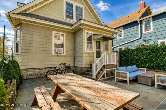 a view of backyard with outdoor seating and plants