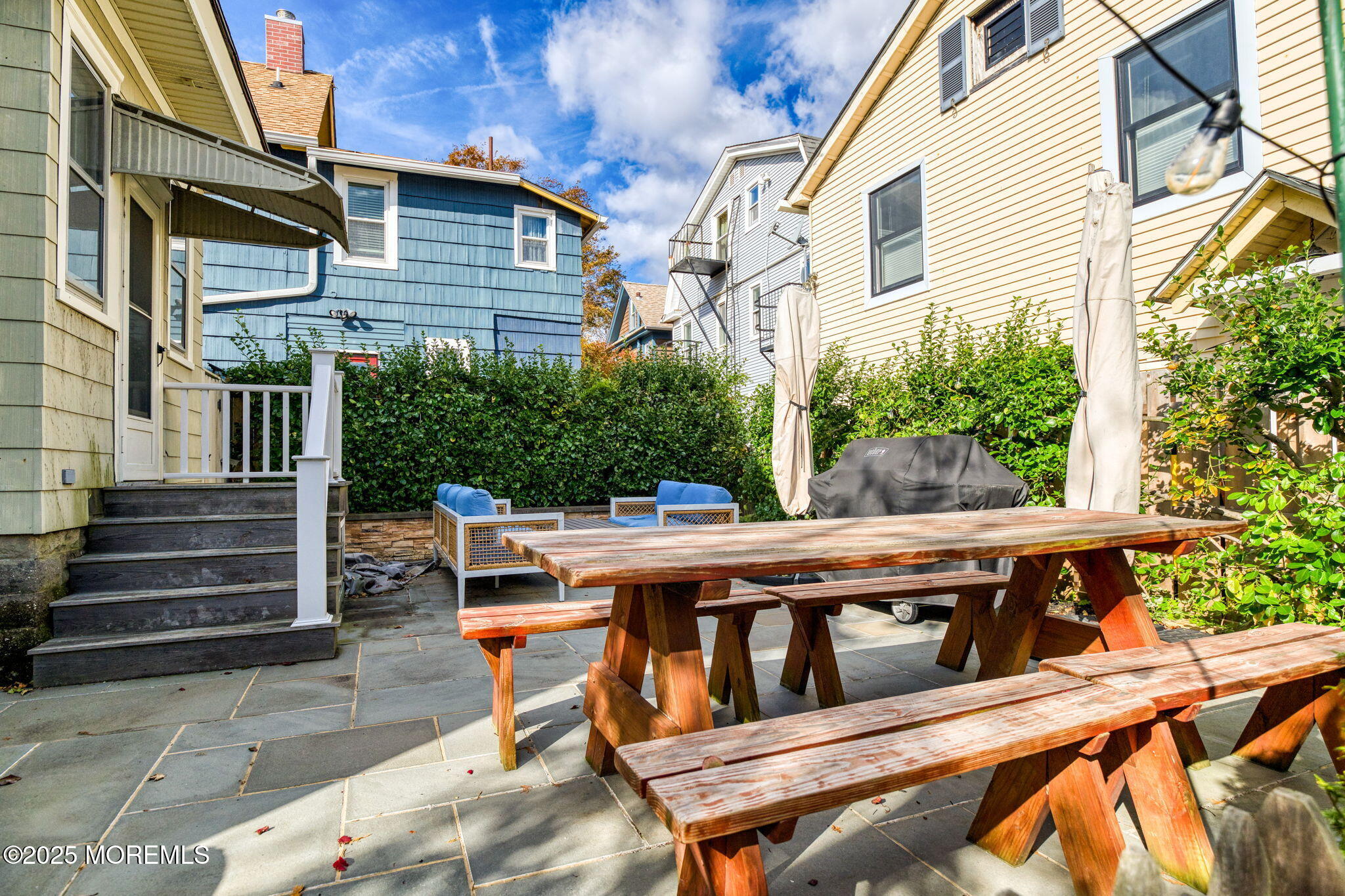 139 Cookman Avenue Ocean Grove, NJ 07756 - Photo 45 of 58 a backyard of a house with wooden chairs and outdoor seating