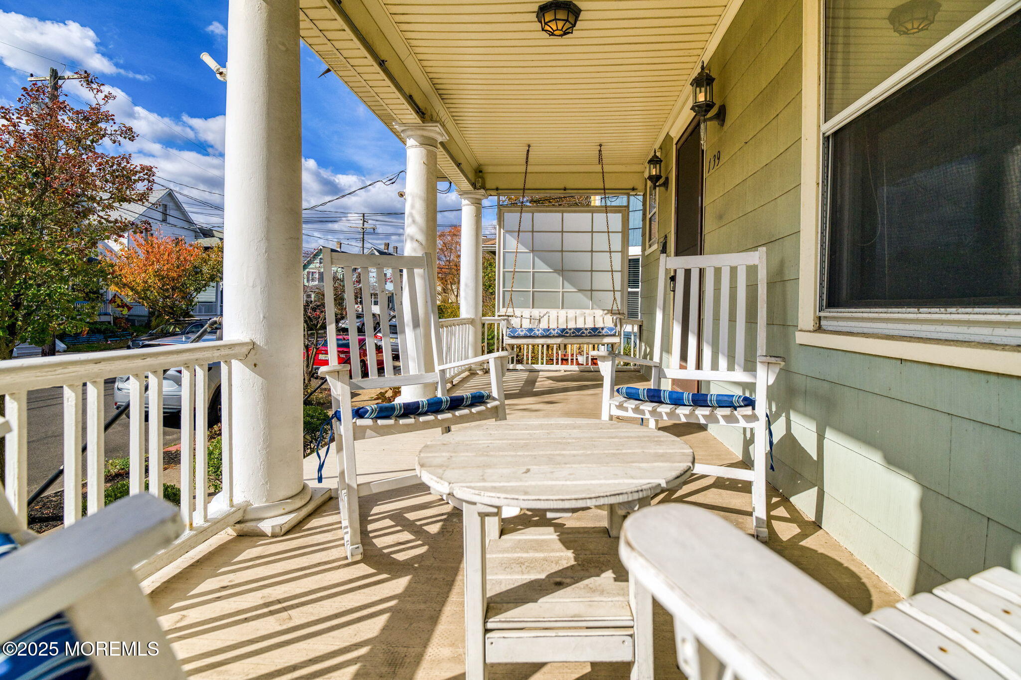 139 Cookman Avenue Ocean Grove, NJ 07756 - Photo 6 of 58 a view of a patio with table and chairs and floor to ceiling window with wooden floor