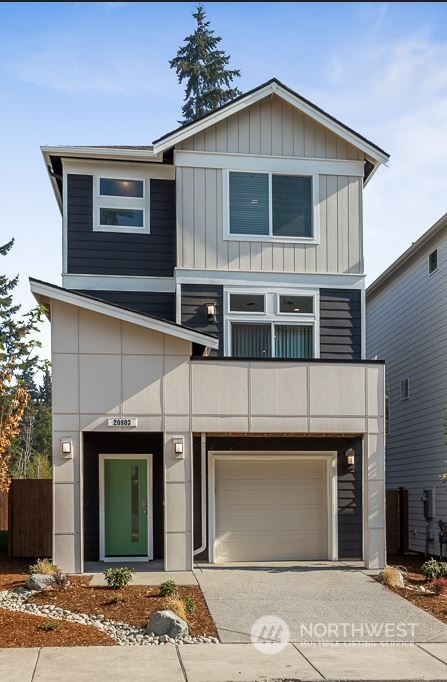 301 207th Place Southeast, Unit EH 31 Bothell, WA 98012 - Photo 2 of 32 a front view of a house with garden