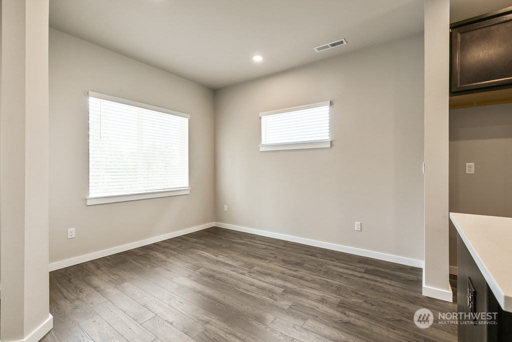 301 207th Place Southeast, Unit EH 31 Bothell, WA 98012 - Photo 31 of 32 a view of an empty room with wooden floor and a window
