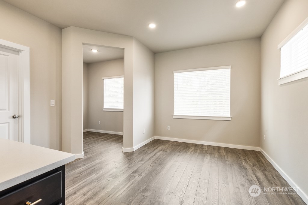 301 207th Place Southeast, Unit EH 31 Bothell, WA 98012 - Photo 32 of 32 an empty room with wooden floor and windows