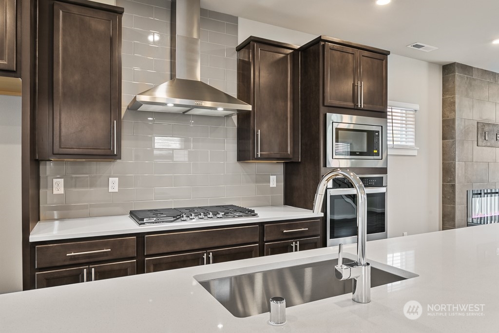 301 207th Place Southeast, Unit EH 31 Bothell, WA 98012 - Photo 8 of 32 a kitchen with stainless steel appliances kitchen island a sink stove and refrigerator