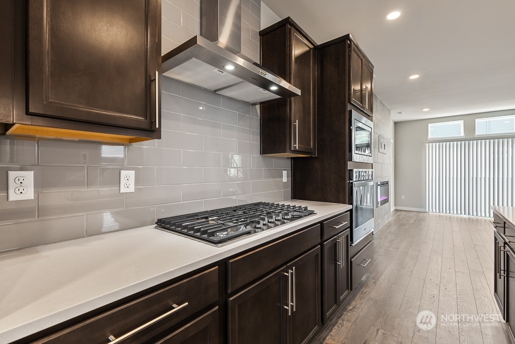 301 207th Place Southeast, Unit EH 31 Bothell, WA 98012 - Photo 10 of 32 a kitchen with stainless steel appliances a stove a sink and a refrigerator