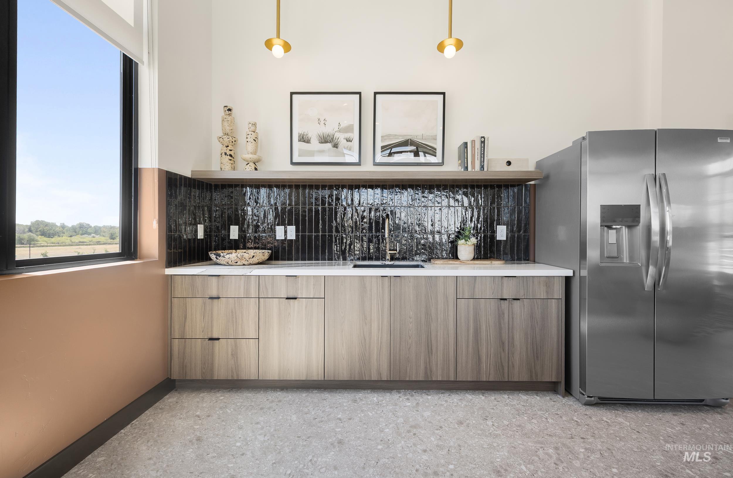 4340 East Haystack Street, Unit 307 Boise, ID 83716 - Photo 30 of 50 Bar area with stainless steel fridge, backsplash, and dark aggregate flooring