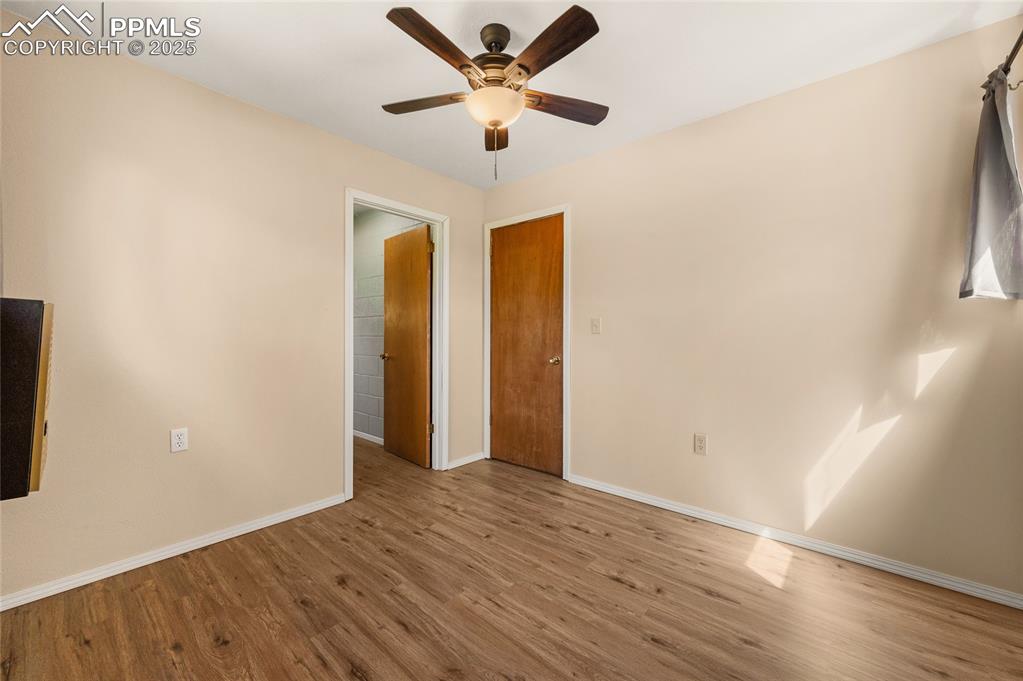 2925 M Path Cotopaxi, CO 81223 - Photo 23 of 27 an empty room with wooden floor and a ceiling fan