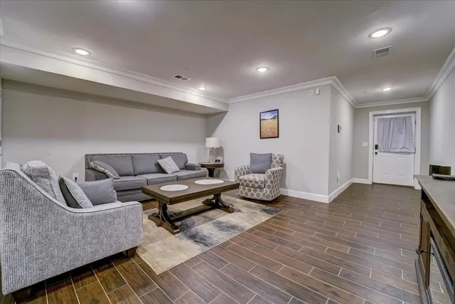a living room with furniture and wooden floor