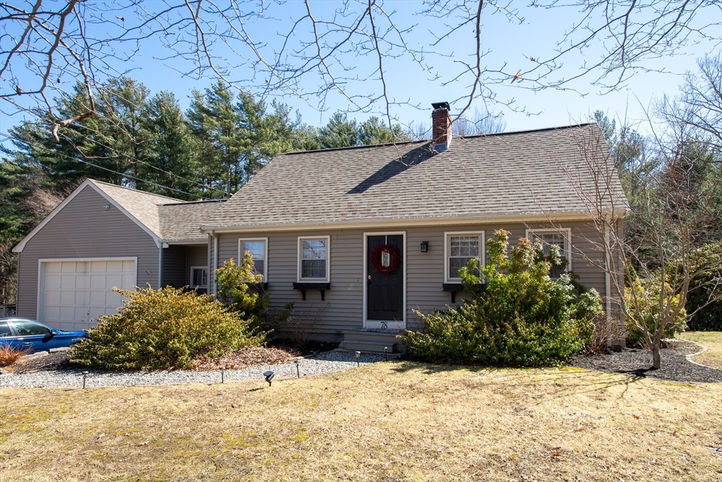 a view of a house with a yard covered in snow