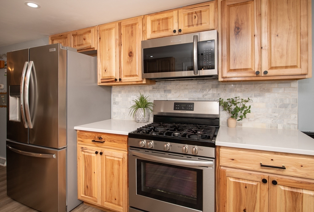 78 Precinct Street Taunton, MA 02718 - Photo 11 of 41 a kitchen with stainless steel appliances a stove a microwave and cabinets