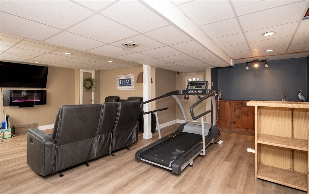 78 Precinct Street Taunton, MA 02718 - Photo 32 of 41 a living room with furniture gym equipment and a flat screen tv