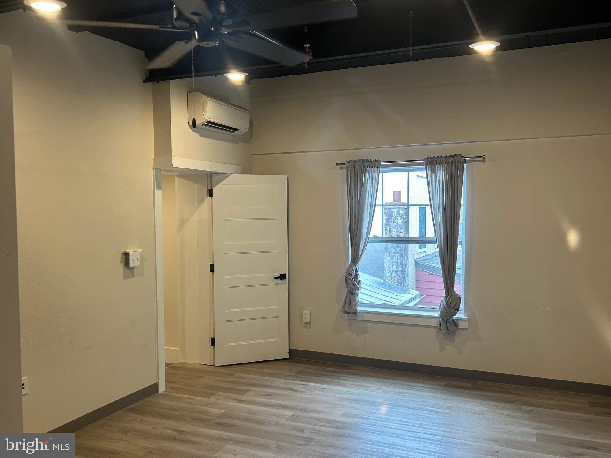 224 Hall Street, Unit 8 Phoenixville, PA 19460 - Photo 13 of 16 a view of an empty room and wooden floor