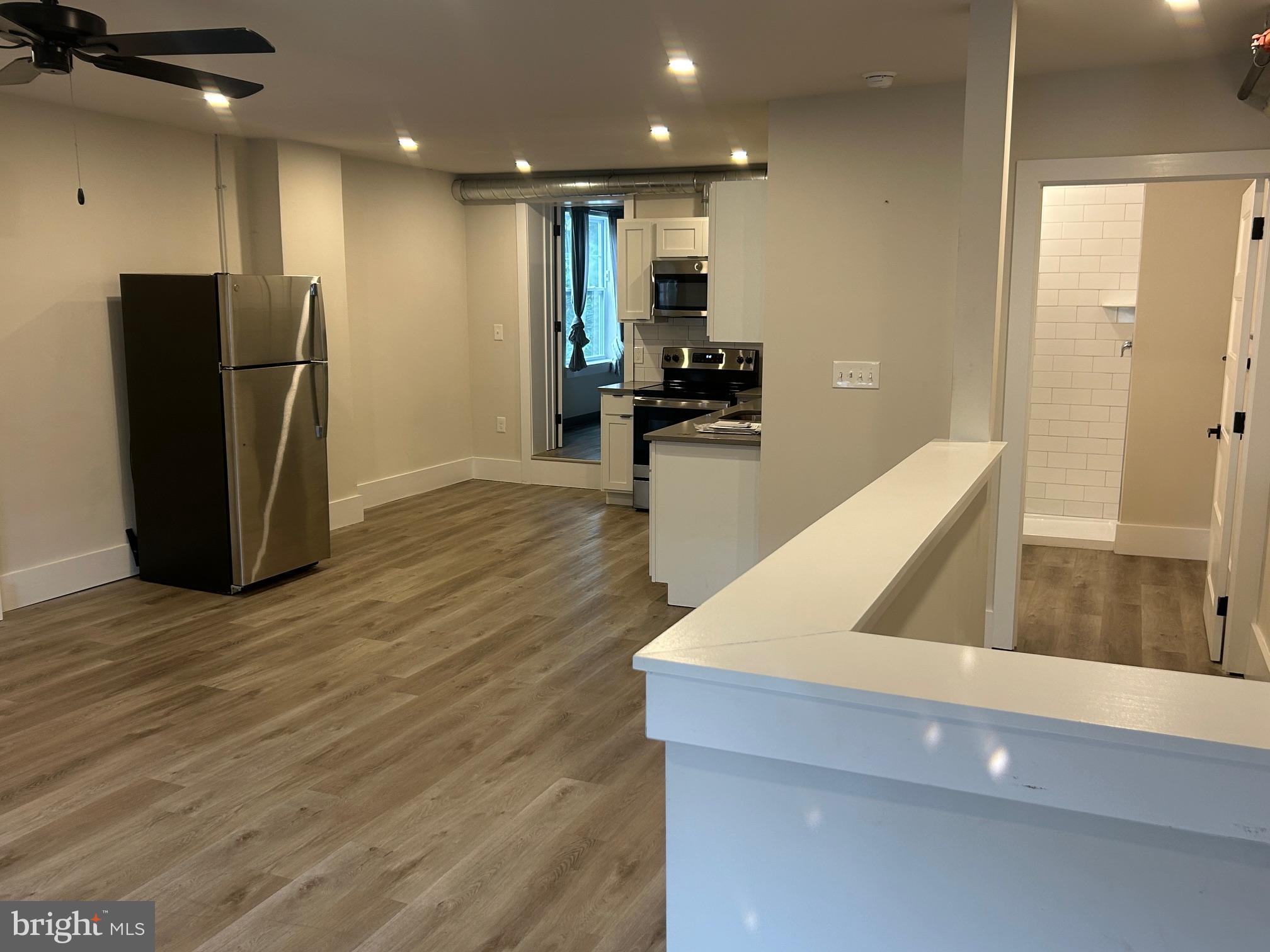 224 Hall Street, Unit 8 Phoenixville, PA 19460 - Photo 3 of 16 a view of kitchen with stainless steel appliances granite countertop a refrigerator and a sink