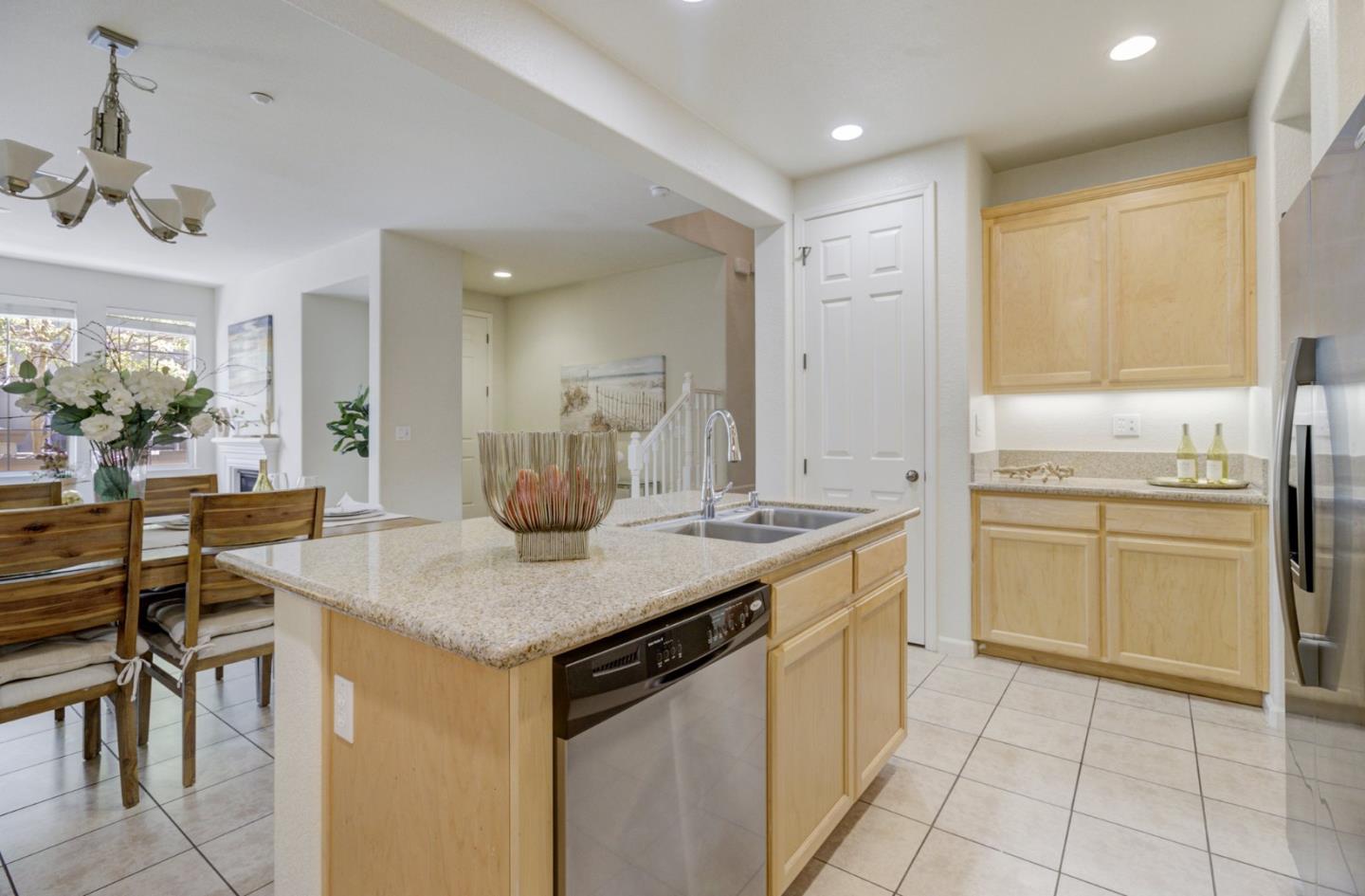 5056 Fioli Loop San Ramon, CA 94582 - Photo 12 of 44 a kitchen with a sink a stove cabinets and chairs