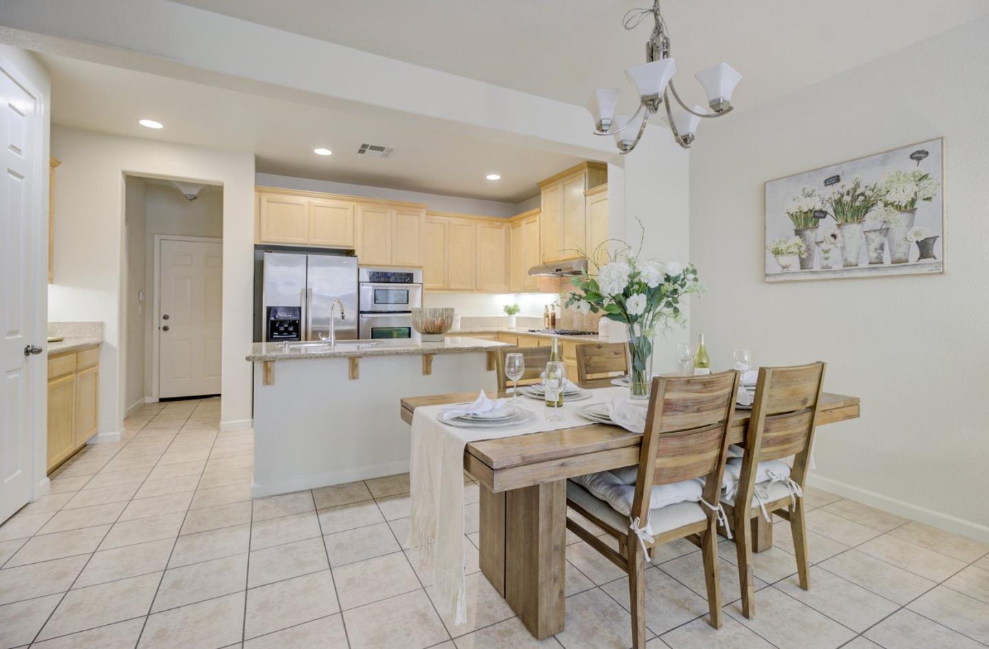 5056 Fioli Loop San Ramon, CA 94582 - Photo 8 of 44 a kitchen with stainless steel appliances kitchen island granite countertop a sink and cabinets