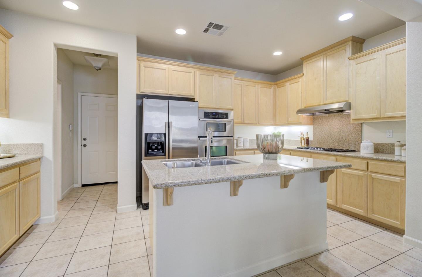 5056 Fioli Loop San Ramon, CA 94582 - Photo 10 of 44 a kitchen with stainless steel appliances granite countertop a sink and a refrigerator