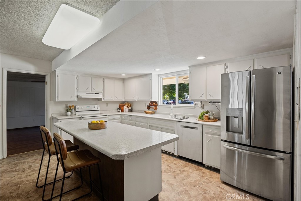 657 Villa Drive Chico, CA 95973 - Photo 14 of 40 a kitchen with white cabinets and white stainless steel appliances