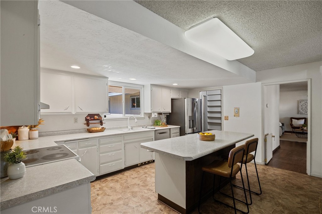 657 Villa Drive Chico, CA 95973 - Photo 15 of 40 a kitchen with a dining table chairs and white stainless steel appliances
