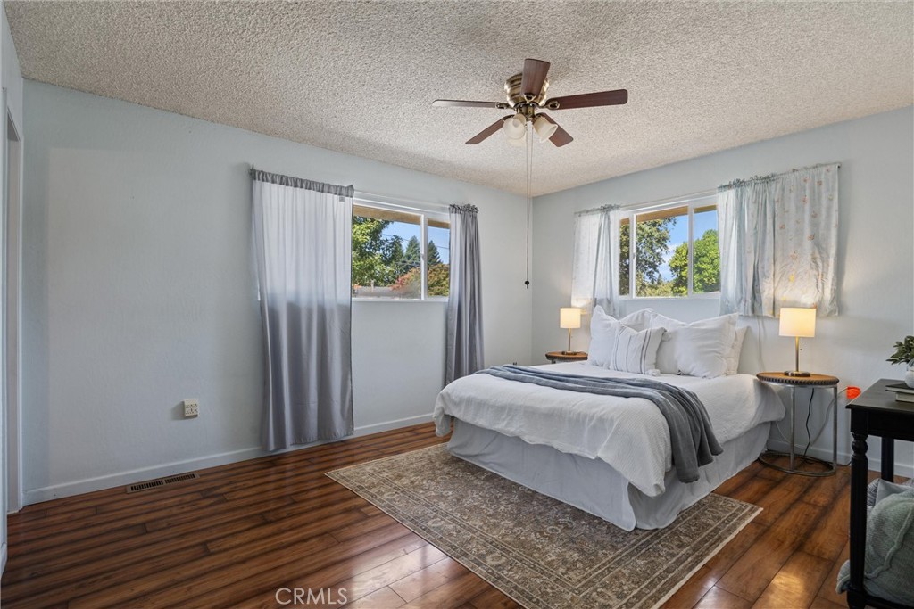 657 Villa Drive Chico, CA 95973 - Photo 21 of 40 a bedroom with a bed a window and painting on the wall