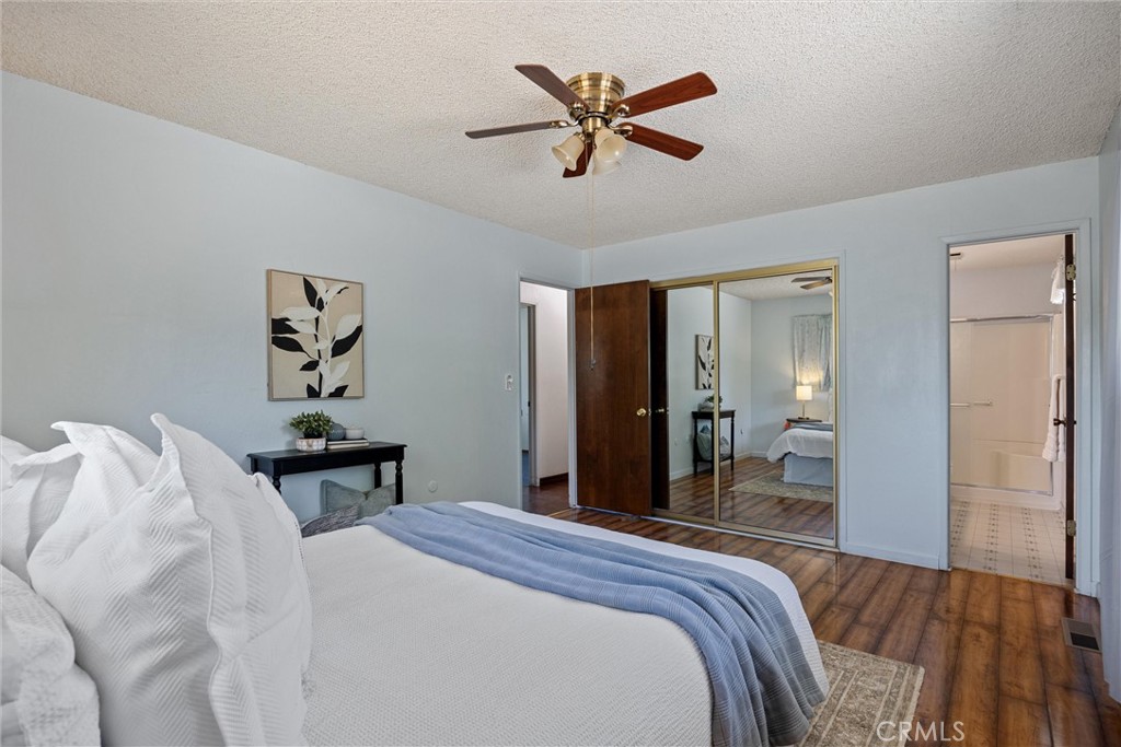 657 Villa Drive Chico, CA 95973 - Photo 22 of 40 a bedroom with a bed and a chandelier