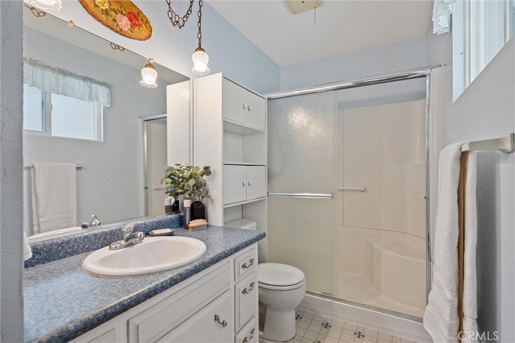 657 Villa Drive Chico, CA 95973 - Photo 23 of 40 a bathroom with a granite countertop sink toilet and shower
