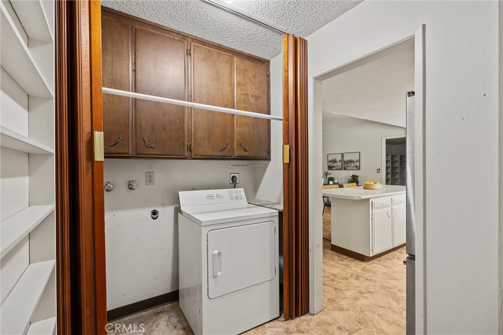 657 Villa Drive Chico, CA 95973 - Photo 27 of 40 a utility room with cabinets washer and dryer
