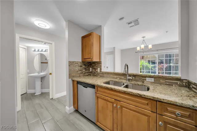 a kitchen with a sink stove and cabinets