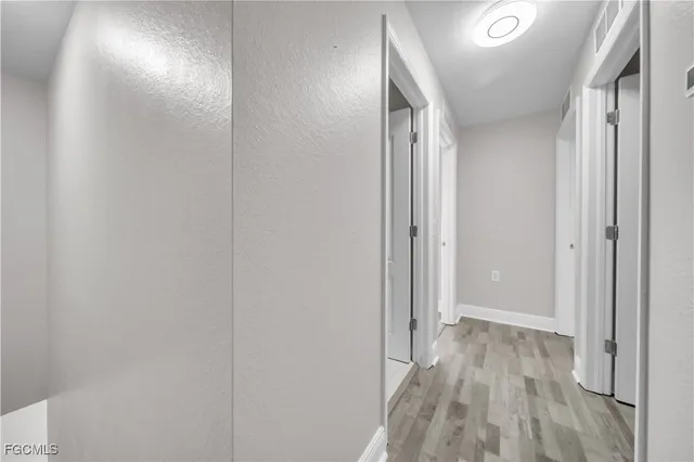 a view of hallway with wooden floor