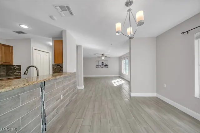 a view of a kitchen with a sink and wooden floor