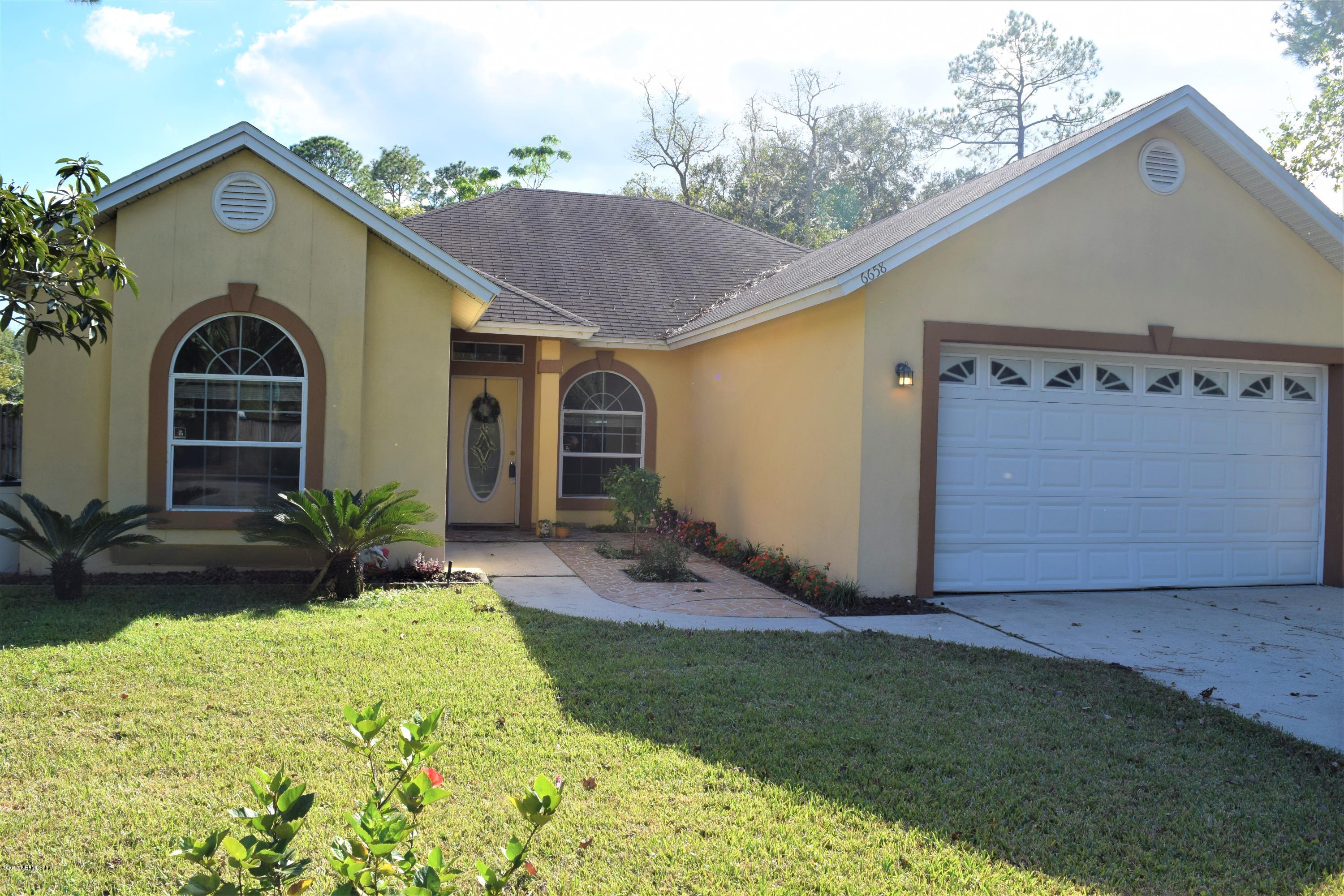 6658 Bennett Road Jacksonville, FL 32216 - Photo 1 of 19 a front view of a house with garden