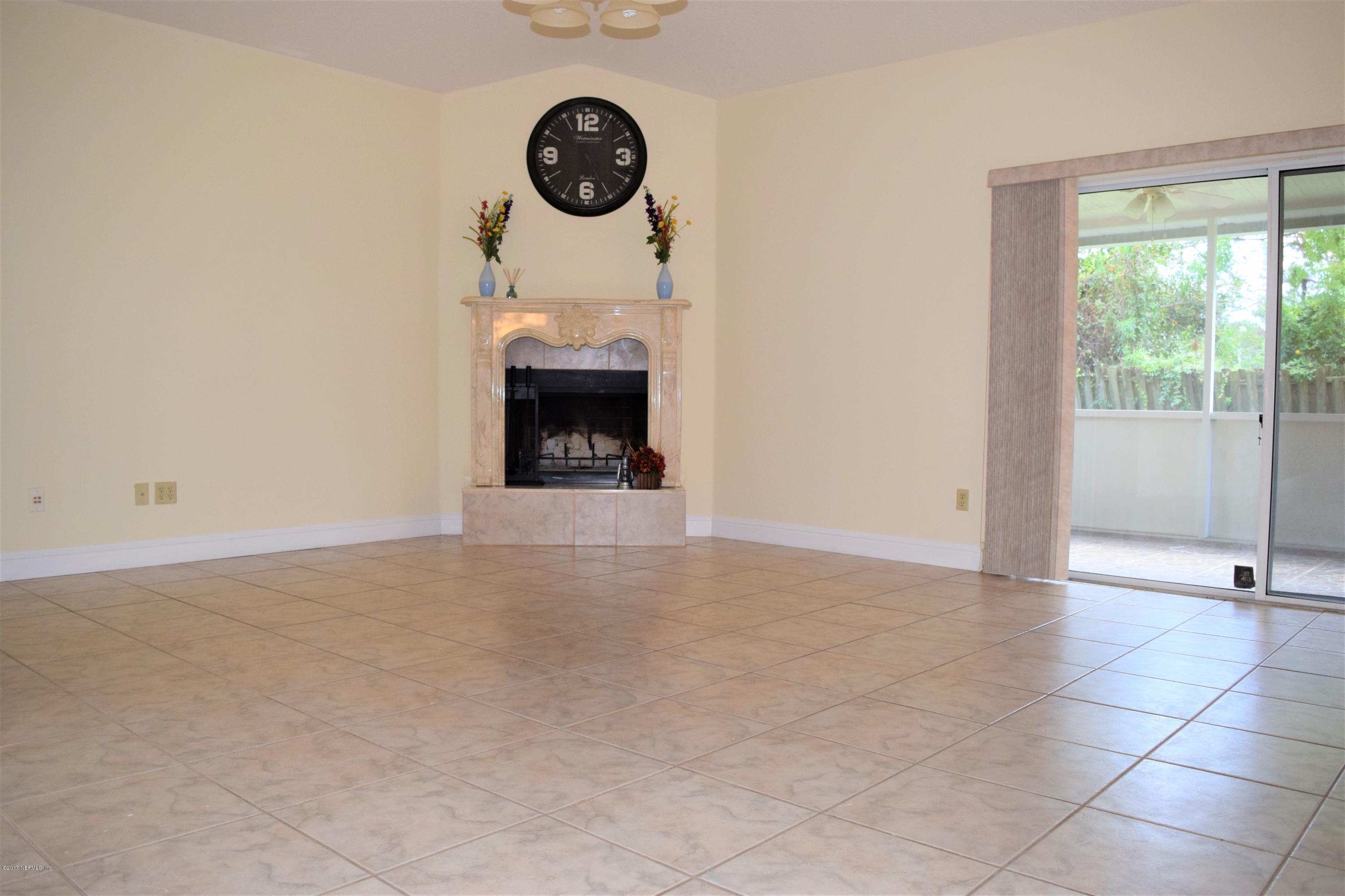 6658 Bennett Road Jacksonville, FL 32216 - Photo 2 of 19 an empty room with a fireplace and a window