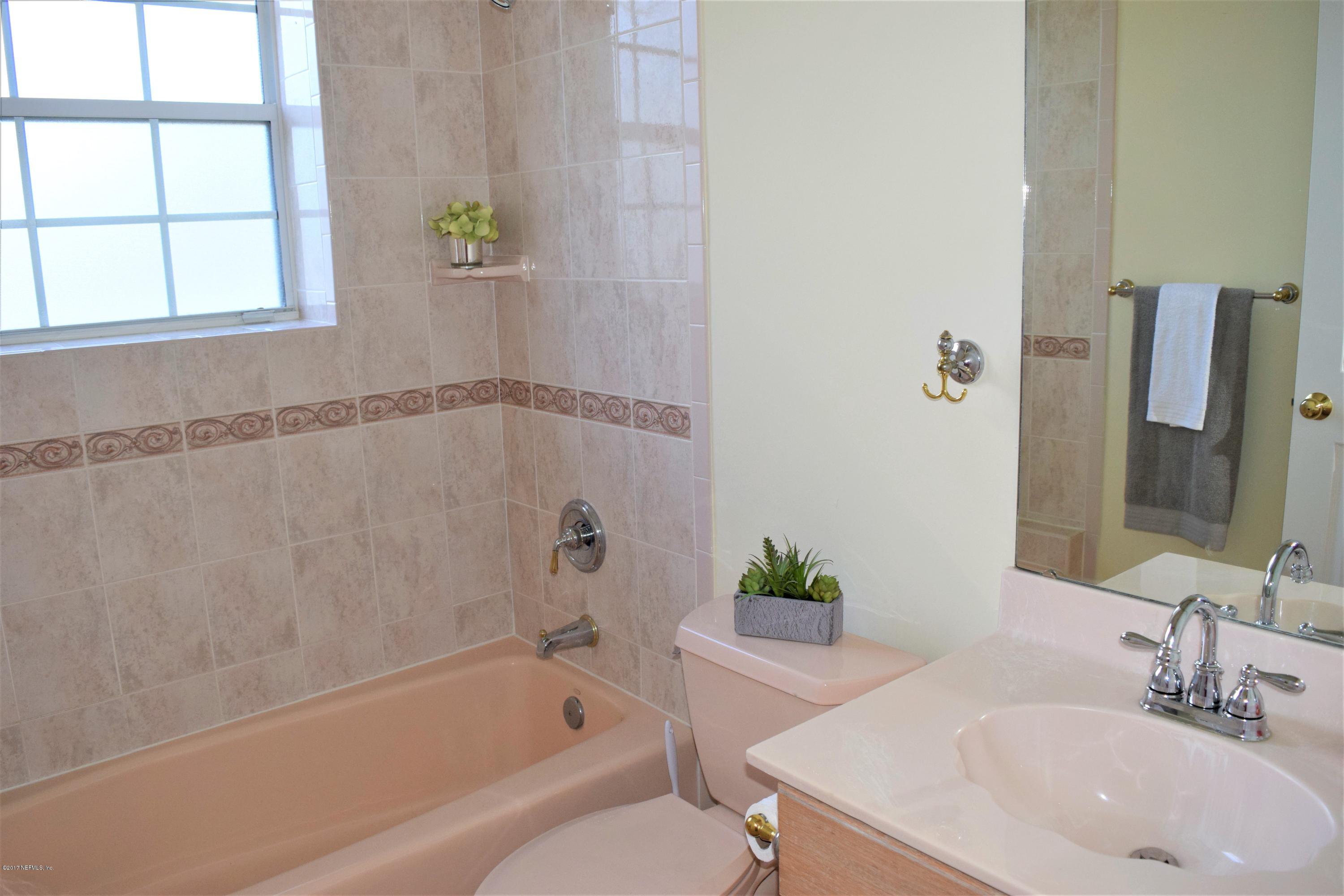 6658 Bennett Road Jacksonville, FL 32216 - Photo 12 of 19 a bathroom with a sink and a bathtub