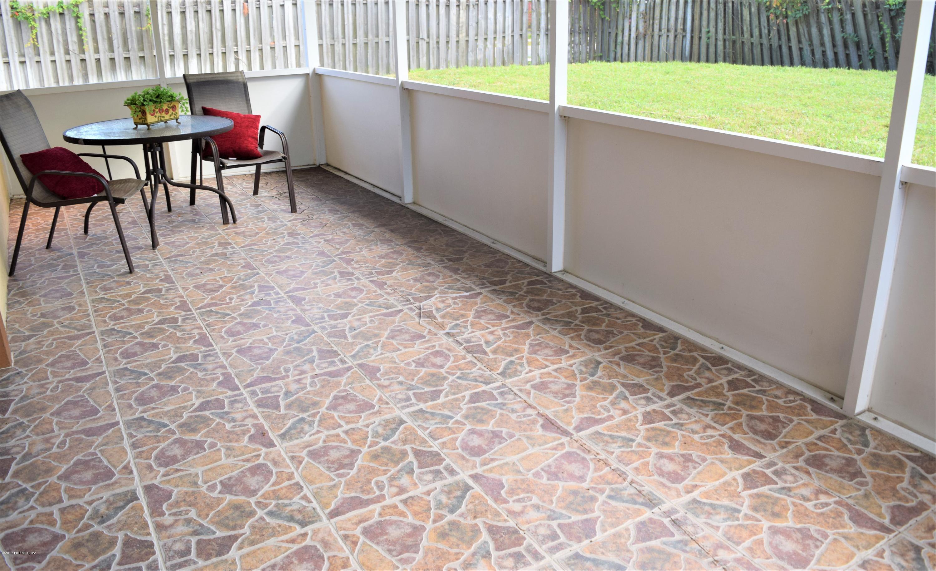 6658 Bennett Road Jacksonville, FL 32216 - Photo 17 of 19 a view of a backyard with table and chairs