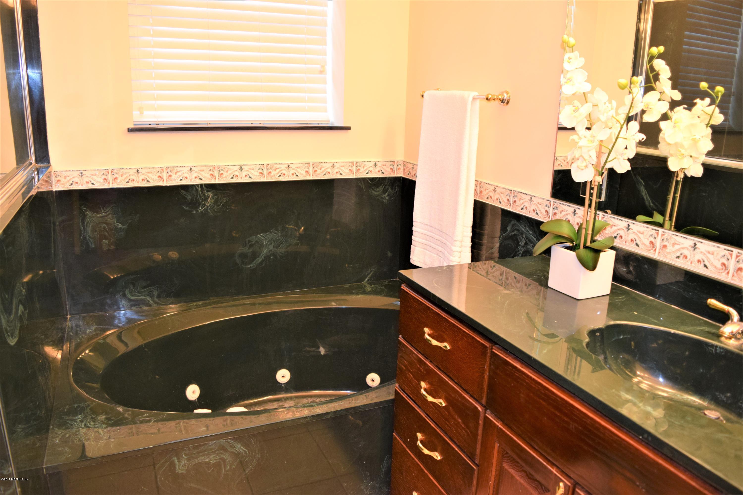 6658 Bennett Road Jacksonville, FL 32216 - Photo 9 of 19 a bathroom with a sink and a mirror